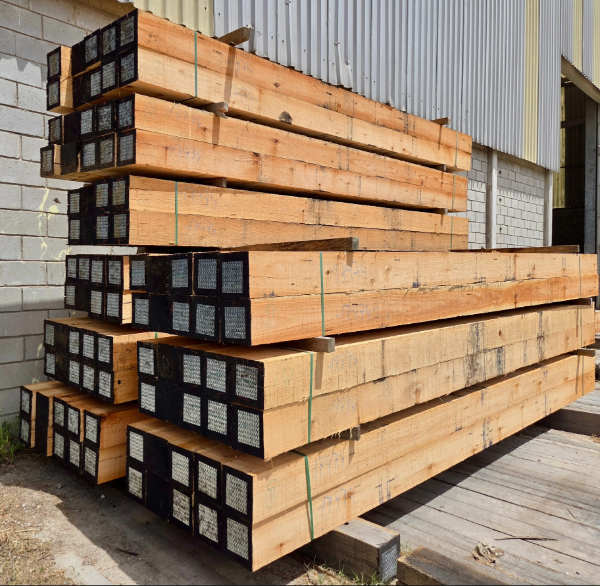 Stacked Eucalyptus timber raw materials in industrial yard